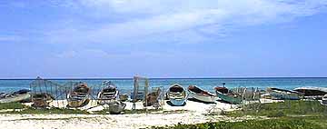 at the fisherman's beach, the boats and fish pots are lined up on the store