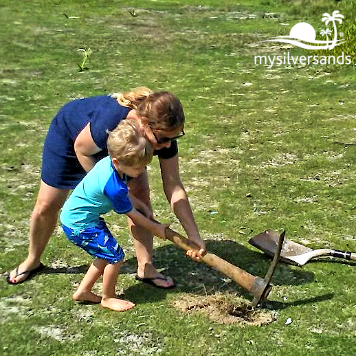woman with boy digging hole