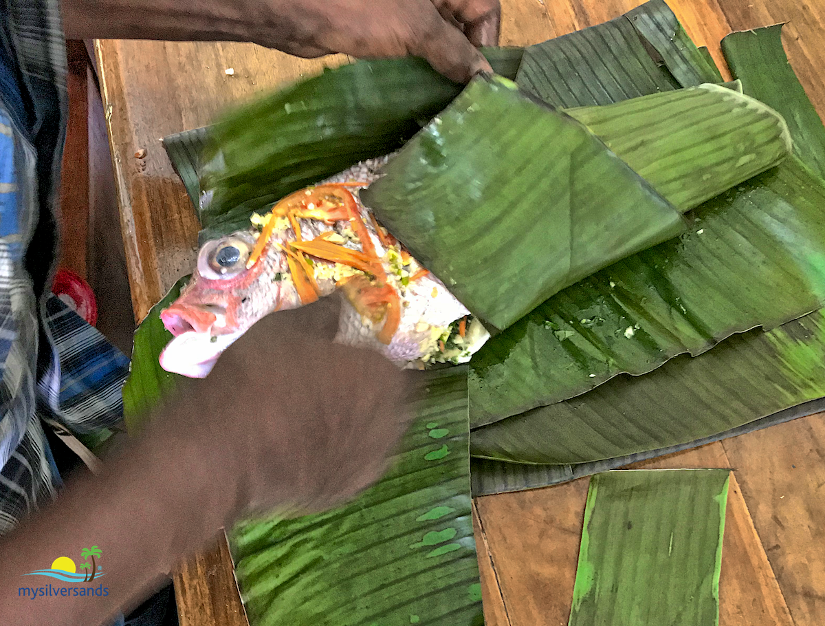 wrapping the fish in banana leaf