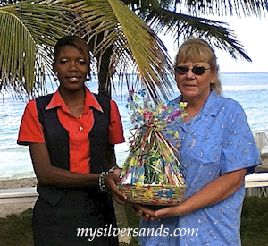 kimesha presents pam sperry with a gift at queen's cottage at silver sands jamaica