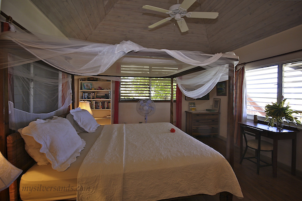 master bedroom at seashell cottage with king bed