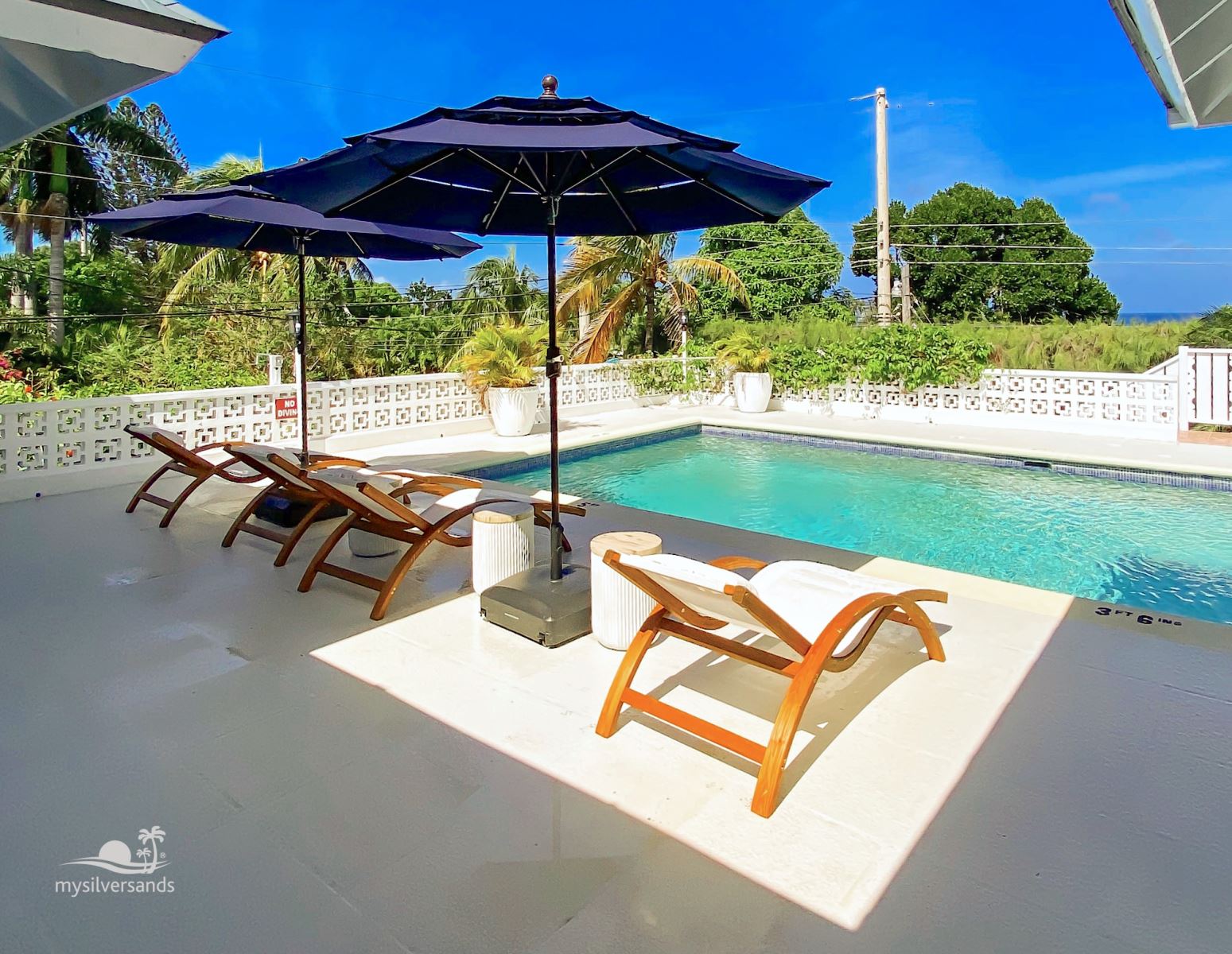 lounge chairs and umbrellas by the pool