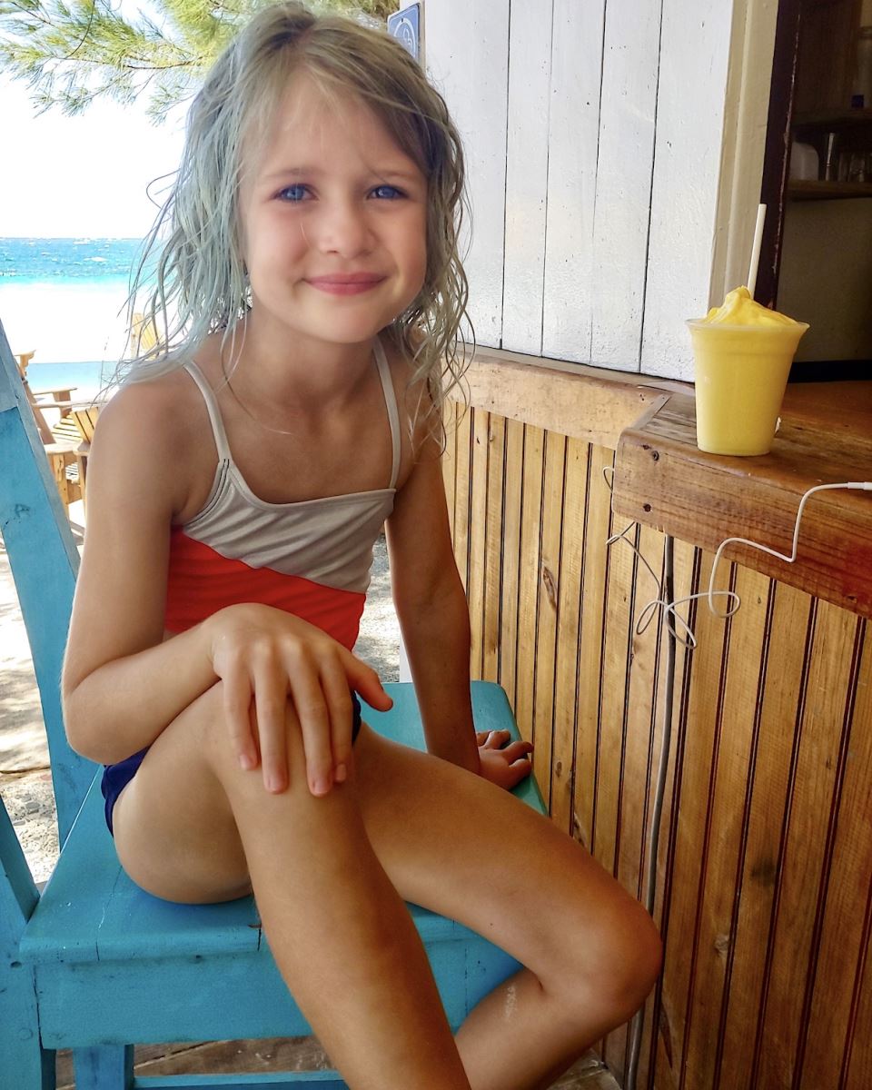 little girl sitting at the bar